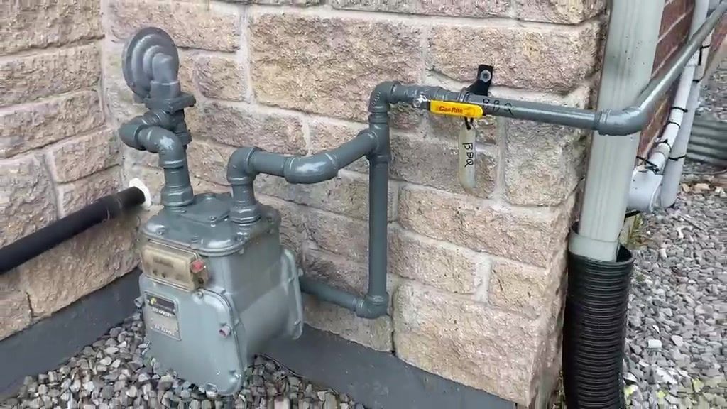A residential gas meter with regulator and riser piping